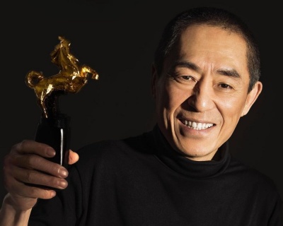 Who is this Chinese film director, producer, and writer that is famous for his movies about the resilience of Chinese people in the face of hardship and adversity.